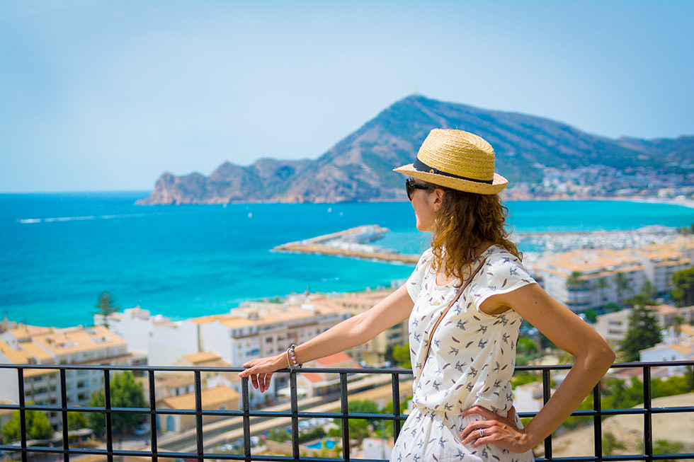 Junge Frau blickt von Altea auf die Küste